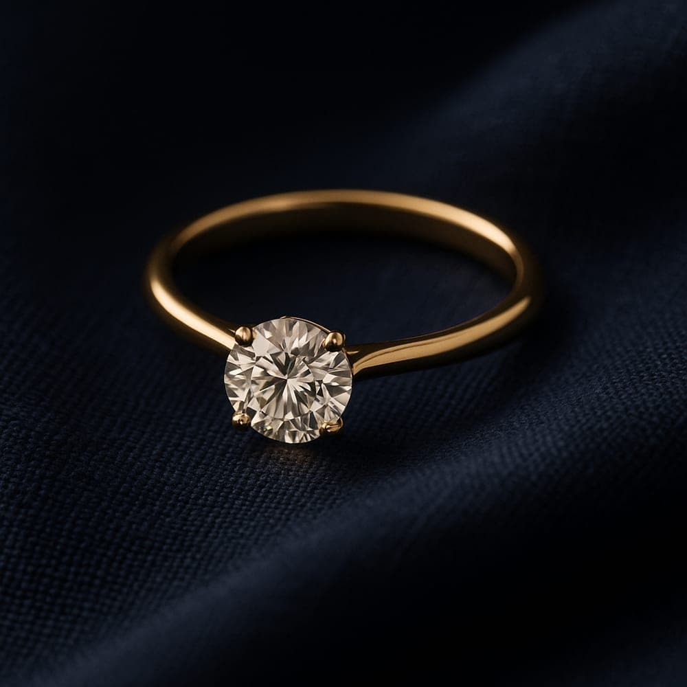 A classic yellow gold solitaire engagement ring with a round brilliant diamond