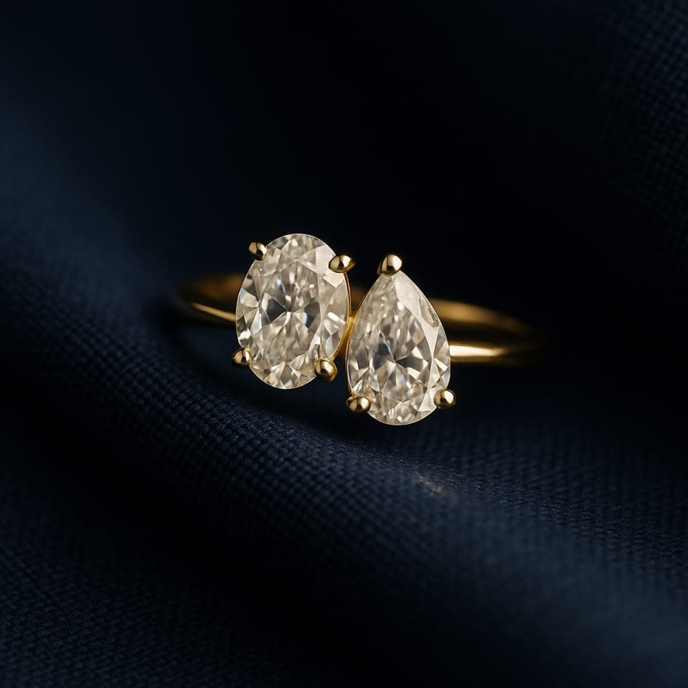 A toi-et-moi two-stone yellow gold ring with an oval and a pear diamond set side by side